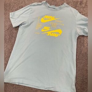 Nike Men's Light Blue Tee with Bold Yellow Graphics